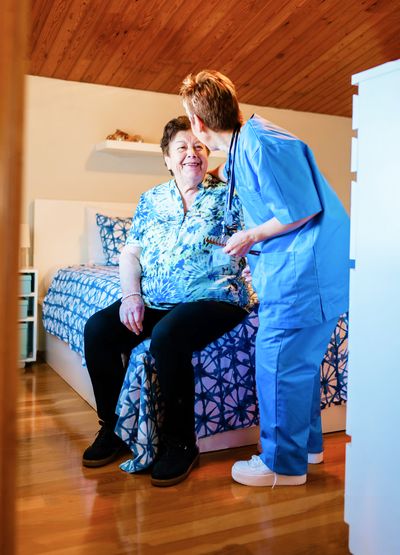 Home health care physician meeting with man in his home and performing a health assessment