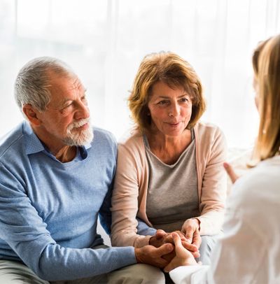 Hopeful married couple consulting with a home health care professional